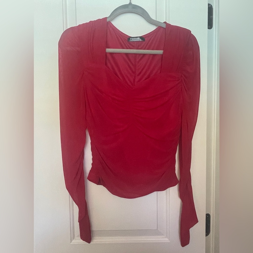 Cute red ruched blouse.